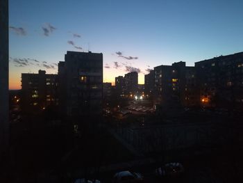 Silhouette buildings against sky at dusk