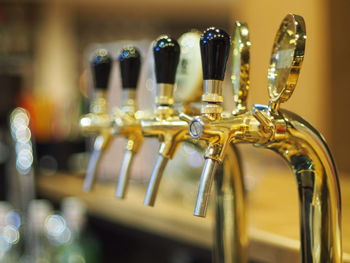 Row of beer taps at bar