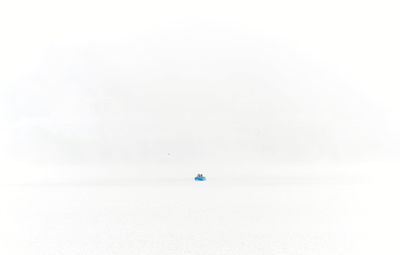 Boat floating on water against white background