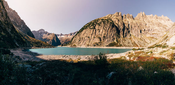 Scenic view of lake and mountains against clear sky