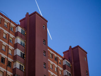 Low angle view of building against clear blue sky