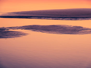 Scenic view of beach against sky during sunset