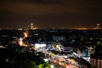 Aerial view of city lit up at night