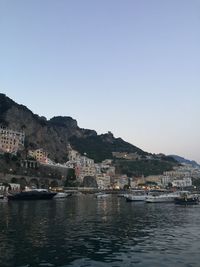 Town by sea against clear sky