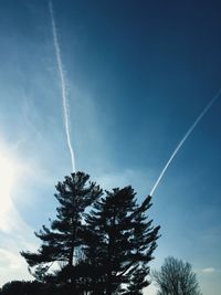 Low angle view of vapor trail against blue sky