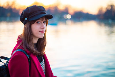 Portrait of young woman in lake during sunset