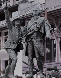 Low angle view of statue against building