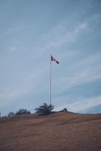 Low angle view of flag against sky