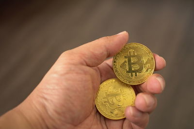 Close-up of hand holding coins