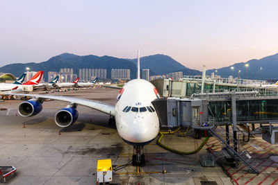 Airplane on airport runway against sky