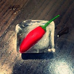 Close-up of red chili peppers on table