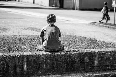 Rear view of girl standing on road