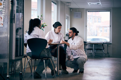 Multi-ethnic chefs discussing menu in restaurant