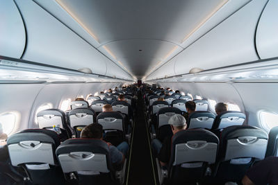 Rear view of people sitting in airplane