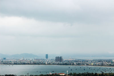 Cityscape against cloudy sky