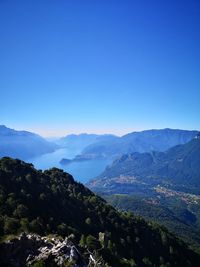 Scenic view of mountains against clear blue sky