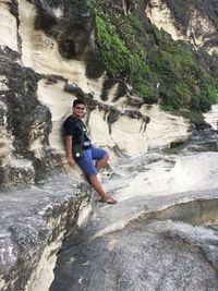 Full length of man standing on rock formation