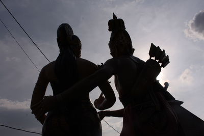 Low angle view of statue against sky