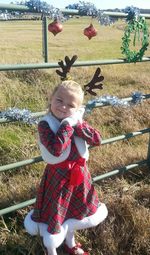 Full length of cute girl smiling in field