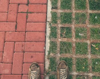 Low section of person standing on footpath