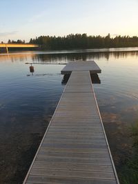 Pier on lake against sky