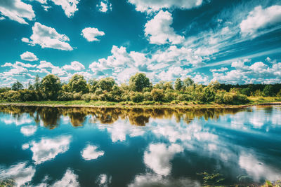 Reflection of trees in lake against sky