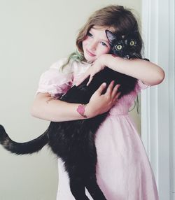 Portrait of smiling girl holding cat