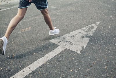 Low section of person running on road