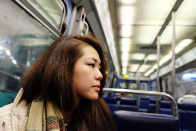 Portrait of beautiful young woman looking away