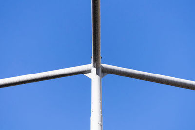 Low angle view of pole against clear blue sky