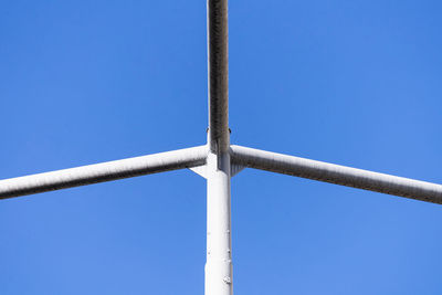 Abstract architectural street light post detail isolated with blue sky background.