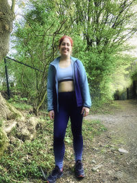 Portrait of smiling young woman standing on land