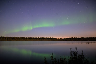 Scenic view of lake against sky at night