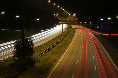 High angle view of light trails on highway at night