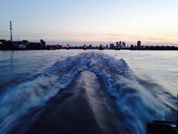 High angle view of wake in river at sunset