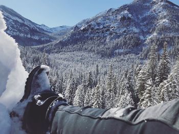 Low section of man on snow 