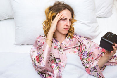 Young woman lying on bed at home