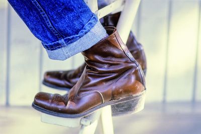 Low section of man sitting on chair