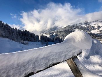 Scenic view of snow covered mountains against sky