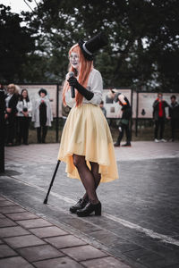 Full length of woman standing with umbrella