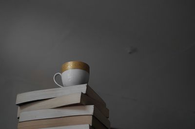 Stack of books on table against wall