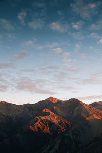 Scenic view of mountain against cloudy sky