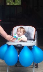 Full length of baby boy sitting on chair