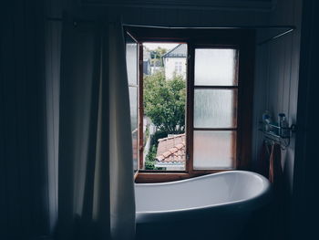 Bathtub by window in bathroom at home