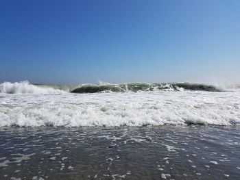 Scenic view of sea against clear blue sky