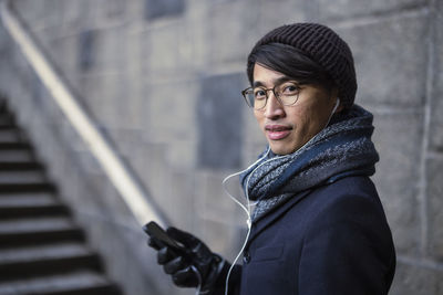 Handsome man with smartphone on street