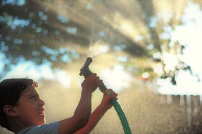 Close-up of boy against sky