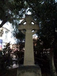 Low angle view of cross in cemetery