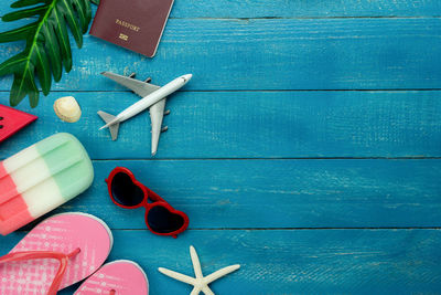 Directly above shot of various objects on blue table