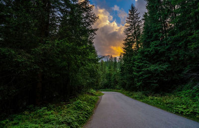 Turning road to the morskie oko against tatra mountains during dramatic sunset or sunrise